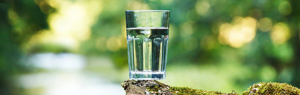 glass of water near a river