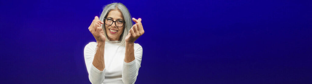 woman making hearts gesture with hands